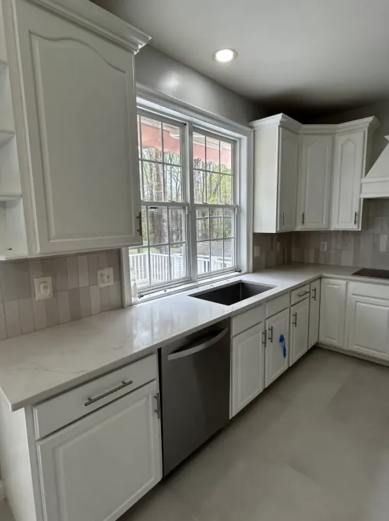 White cabinetry kitchen with gray rectangular backsplash