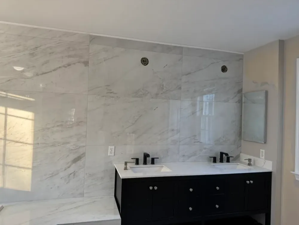 White veined-tile bathroom with corner tub and shower